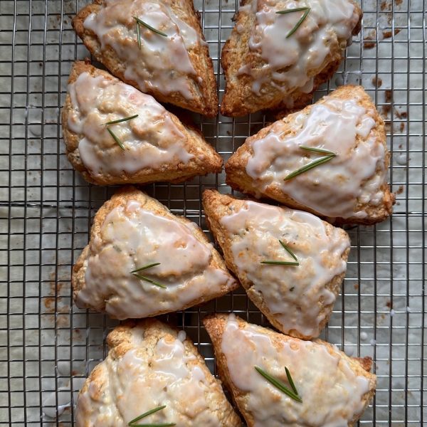 Picture of eight grapefruit rosemary scones with a thin glaze.