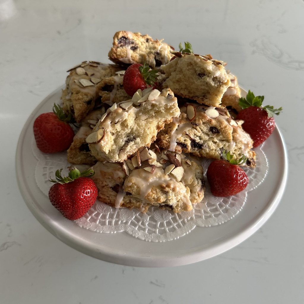 strawberry scones, decorated with whole fresh strawberries, served on a cake stand